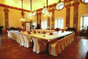 a large dining room with a long table and chairs at Zámek Potštejn in Potštejn