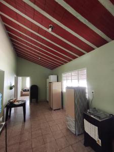 a room with two refrigerators and a ceiling with red at Chácara Angola in Andradas
