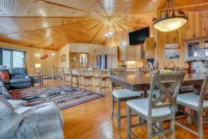 a dining room and living room with a wooden ceiling at Dock & Beach Access: Scenic Lake Ossipee Cabin! in Center Ossipee