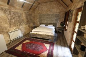 a small room with a bed and a rug at Dili Dzor in Dilijan