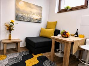 a living room with a couch and a table at Slatkiš Sweet in Banja Koviljača