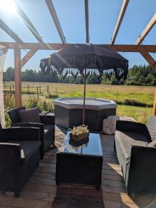 a patio with a table and an umbrella at Kolsta Gård  +30 photos