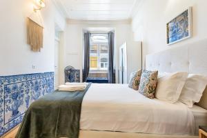 a bedroom with a large white bed in a room at Gonzalo's Guest Apartments - Downtown Historic Flats in Lisbon