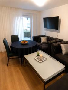 a living room with a table and a couch at Apartment am Rhein in Bonn