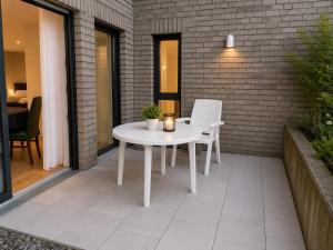 a white table and chairs on a patio at Apartment am Rhein in Bonn