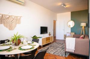 a living room with a table and a couch at Apartamento T3 Belém in Maputo