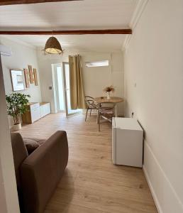 a living room with a couch and a table at La Maison Fleurie in San Nicola Arcella