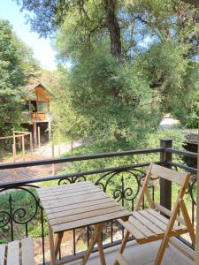 a wooden bench sitting on top of a balcony at Dili Dzor in Dilijan