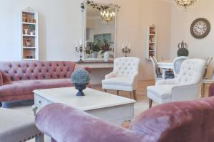 a living room with couches and chairs and a table at Château De Chaussy in Ruoms