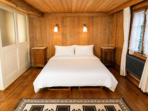 a bedroom with a large white bed in a room at Klösterli Malters in Malters +11 photos
