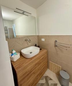 a bathroom with a sink and a mirror at La Maison Fleurie in San Nicola Arcella