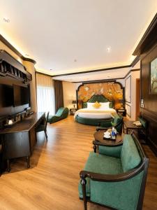a large hotel room with a bed and a desk at Halo hotel & Spa hanoi in Hanoi