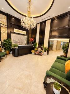 a hotel lobby with a chandelier and a living room at Halo hotel & Spa hanoi in Hanoi