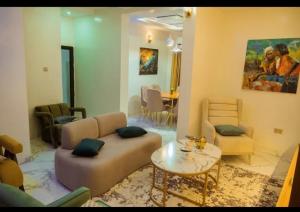 a living room with a couch and a table at Blu Atlantic Apartment in Oshogbo