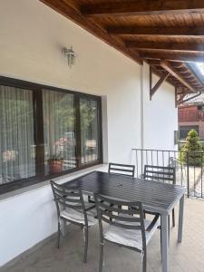 a black table and chairs on a patio at Pensiunea Funivia in Săcele