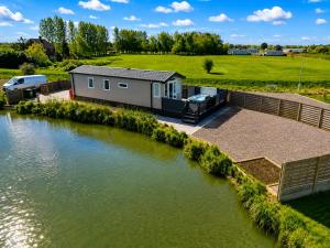 an aerial view of a tiny house next to a river at Parkside Fishery in Skegness +37 photos