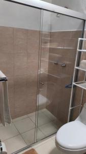 a glass shower in a bathroom with a toilet at Mejor relación Precio Comodidad in San Diego