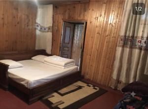 a small room with a bed and a window at Guest House Nino in Mestia