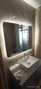 a bathroom with a sink and a large mirror at Casa Ligoustra in Kalithies +23 photos