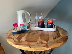 a table with a coffee maker and drinks on it at Ti Toenn et spa in Landéda +23 photos