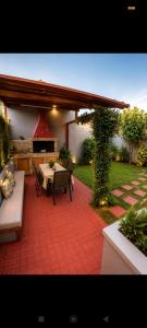 a patio with a table and chairs and a fireplace at Vasiliki apartment in Kalamata