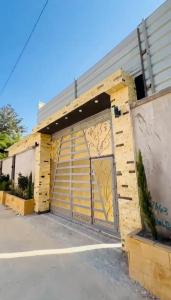 a building with a garage door with graffiti on it at فيلا في كينج مريوط in Alexandria +5 photos