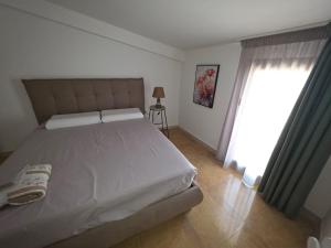 a bedroom with a large bed and a window at MARE FUORI LUXURY B&b in Cassano delle Murge