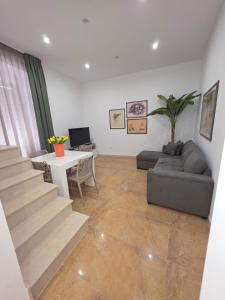 a living room with a couch and a table at MARE FUORI LUXURY B&b in Cassano delle Murge