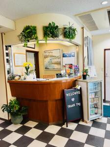 a counter in a store with plants on the wall at Pension Green Grass in Kamakura