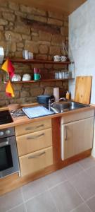 a kitchen with a sink and a stove at Haus Rothenberg - Wohnung Anne in Nohfelden +10 photos
