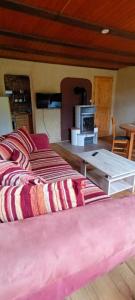 a room with two beds and a table with a stove at Haus Rothenberg - Wohnung Anne in Nohfelden