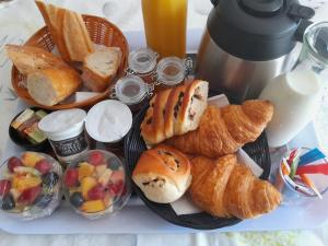 a plate of bread and pastries on a table at Chez Flo&Fred Caravane Vintage in Barbery +12 photos