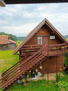 a large wooden house with a large deck at Zacisze pod lasem in Ruciane-Nida