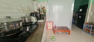 a kitchen with a stove and a sign on the counter at Grandma House in Can Tho