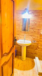 a bathroom with a sink and a wooden wall at Sun Lake Hotel in Tunis +45 photos