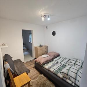 a bedroom with a bed and a dresser and a mirror at Domki Oliwia in Łeba