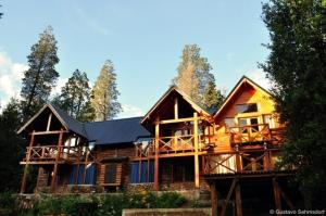 a large wooden house in the woods at Cabañas Las Maras in Villa La Angostura