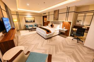 a hotel room with a bed and a living room at Hotel Space Crest in Faisalabad