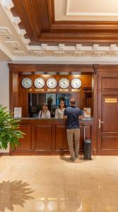 a man standing at a counter at a bar at Grand Capital Hotel in Tashkent +59 photos