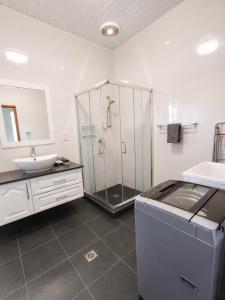 a bathroom with a shower and a sink at Trwa Koko Self-catering in Grand'Anse Praslin