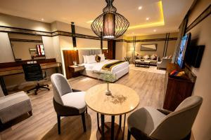 a hotel room with a bed and a table and chairs at Hotel Space Crest in Faisalabad