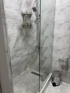a shower with a glass door in a bathroom at shahrisabz city hotel in Shahrisabz