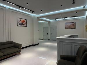 a living room with a couch and a bar in it at shahrisabz city hotel in Shahrisabz +20 photos