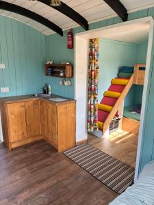 a room with a sink and a bunk bed at Shepherds Hut (Benny's) in Cullompton