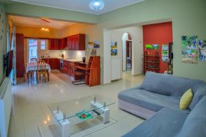 a living room with a blue couch and a glass table at Mpoulakis Apt 98 in Kissamos