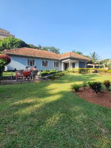 two people sitting at a table outside of a house at JOSIRE Residence in Entebbe