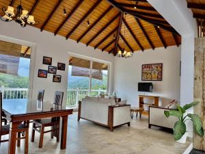 a living room with a table and chairs and a television at Nature Breeze Boutique Villa in Kandy