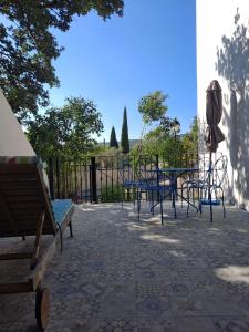 a group of tables and chairs in front of a fence at BEAU STUDIO NEUF en provence in Pélissanne