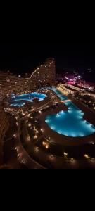 a view of a city at night with blue water at ساوث بيتش بورتو السخنه in Ain Sokhna +5 photos