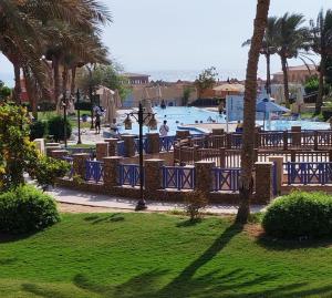 a resort with a swimming pool with people in it at ساوث بيتش بورتو السخنه in Ain Sokhna
